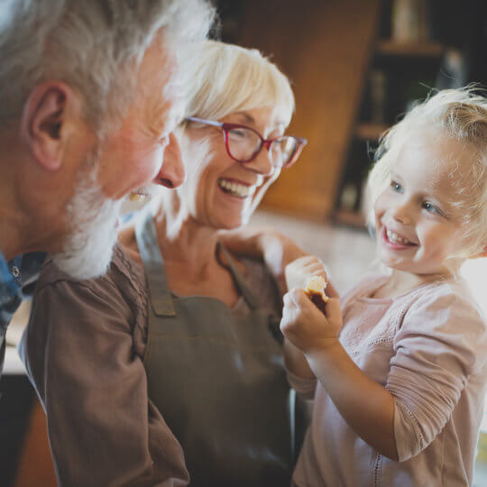 Grandparents with their grand child | Featured image for the Children’s Funerals service landing page.