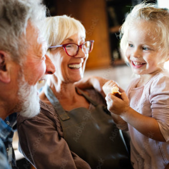 A child with her grandparents | Featured image for the viewing services page of Academy Funerals.